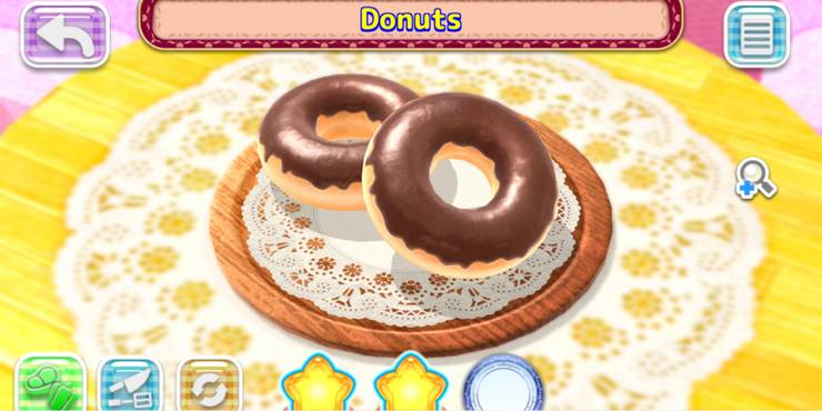 Two Donuts with chocolate frosting on a plate with tuile