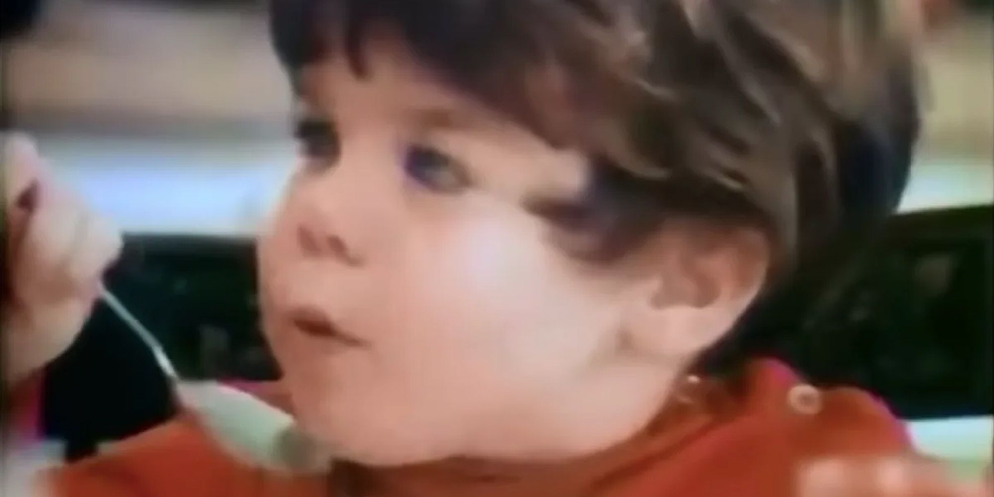 Mikey, a young boy, enjoys a bowl of Life cereal.