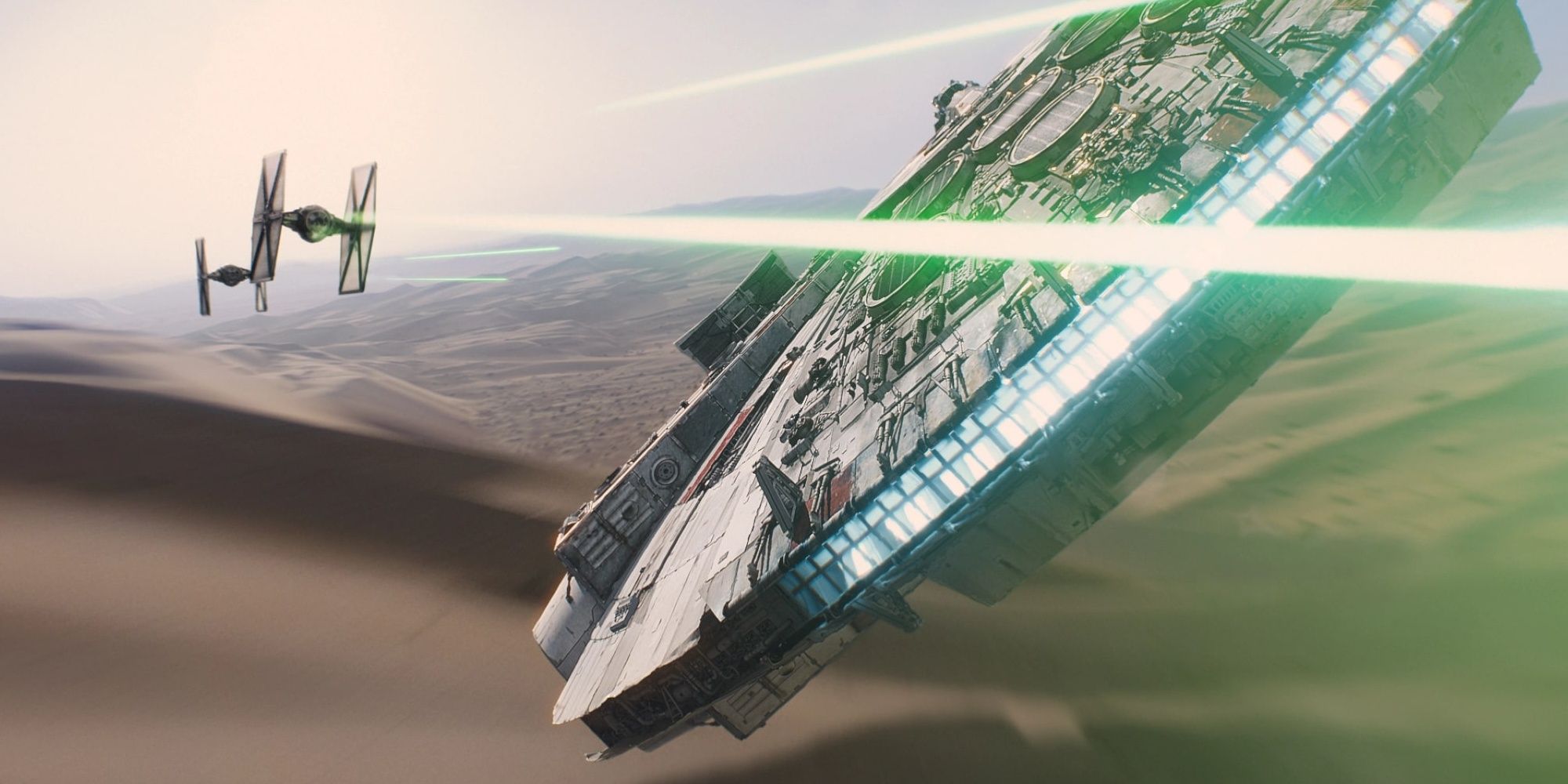 The Millenium Falcon in a dogfight in the desert in Star Wars: The Force Awakens
