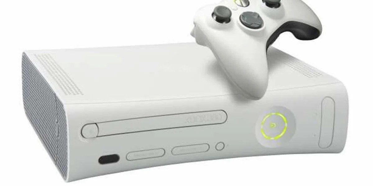 An original xbox 360 lying horizontally with a controller atop it