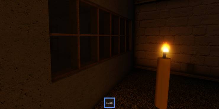A single candle held up in a dark room, where a window can be seen