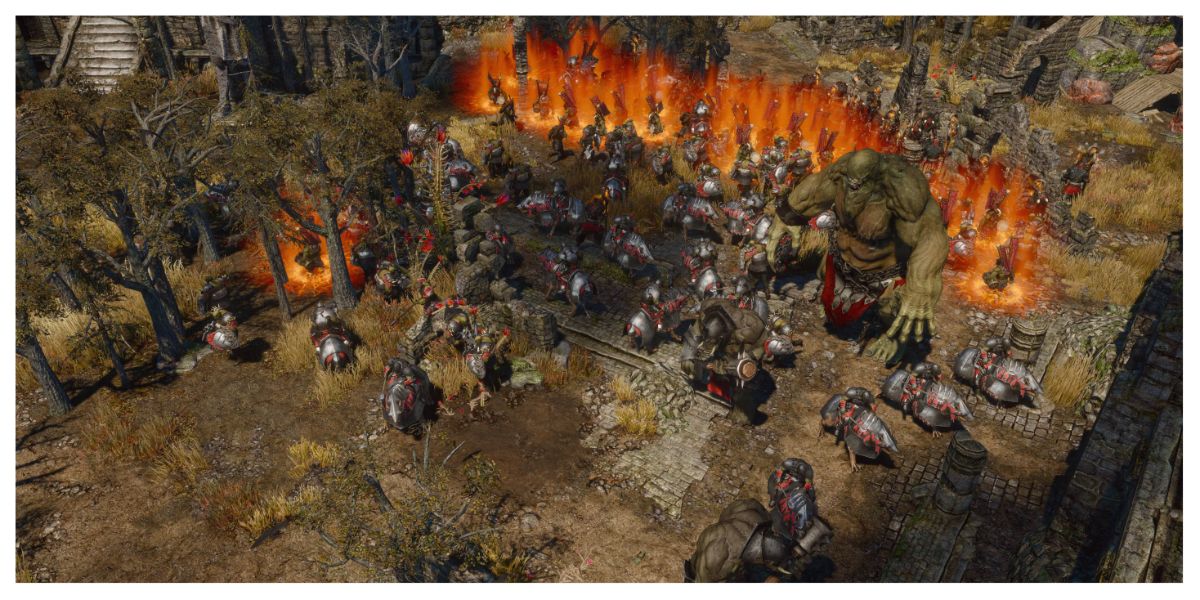 army of enemy soldiers including huge monstrous orcs and other creatures stand ready. a wall of flames is behind them and they are ready for battle