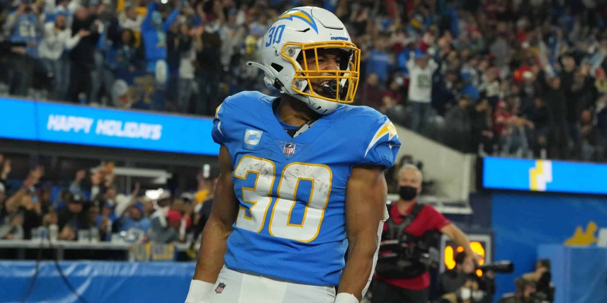 Austin Ekeler yelling during a touchdown celebration in powder blue Chargers jersey