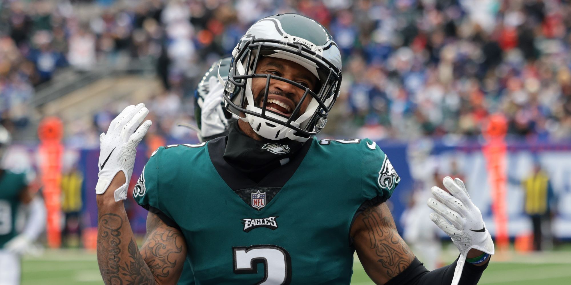 Darius Slay laughing on the field in a green Eagles uniform