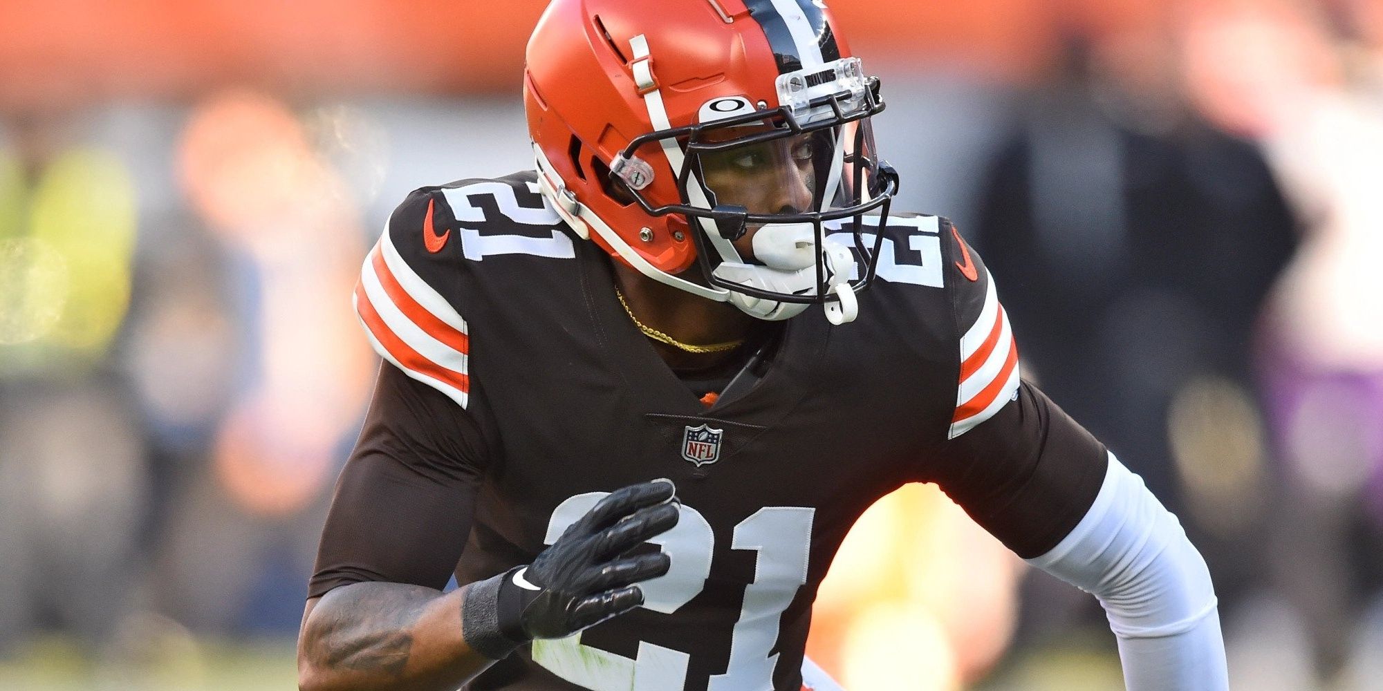 up close shot of Denzel Ward running in his brown and orange Browns uniform