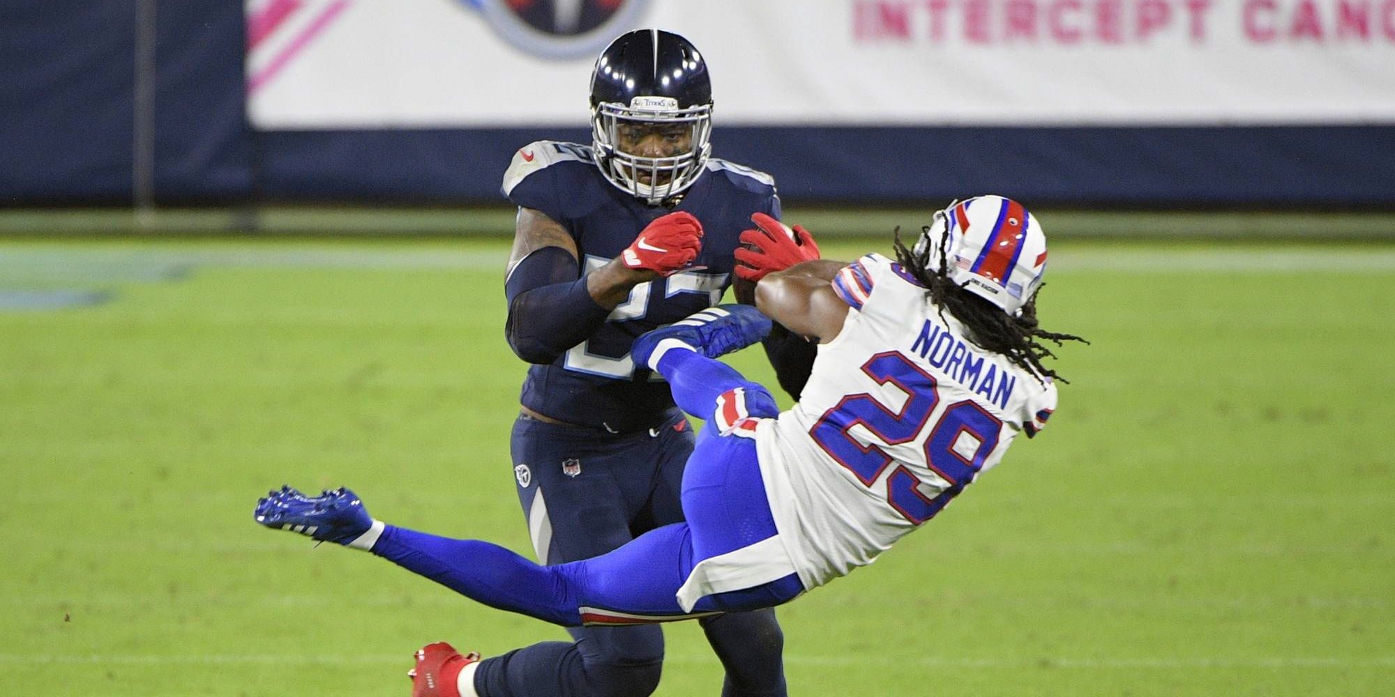 Derrick Henry stiff arming a Bills player on a run