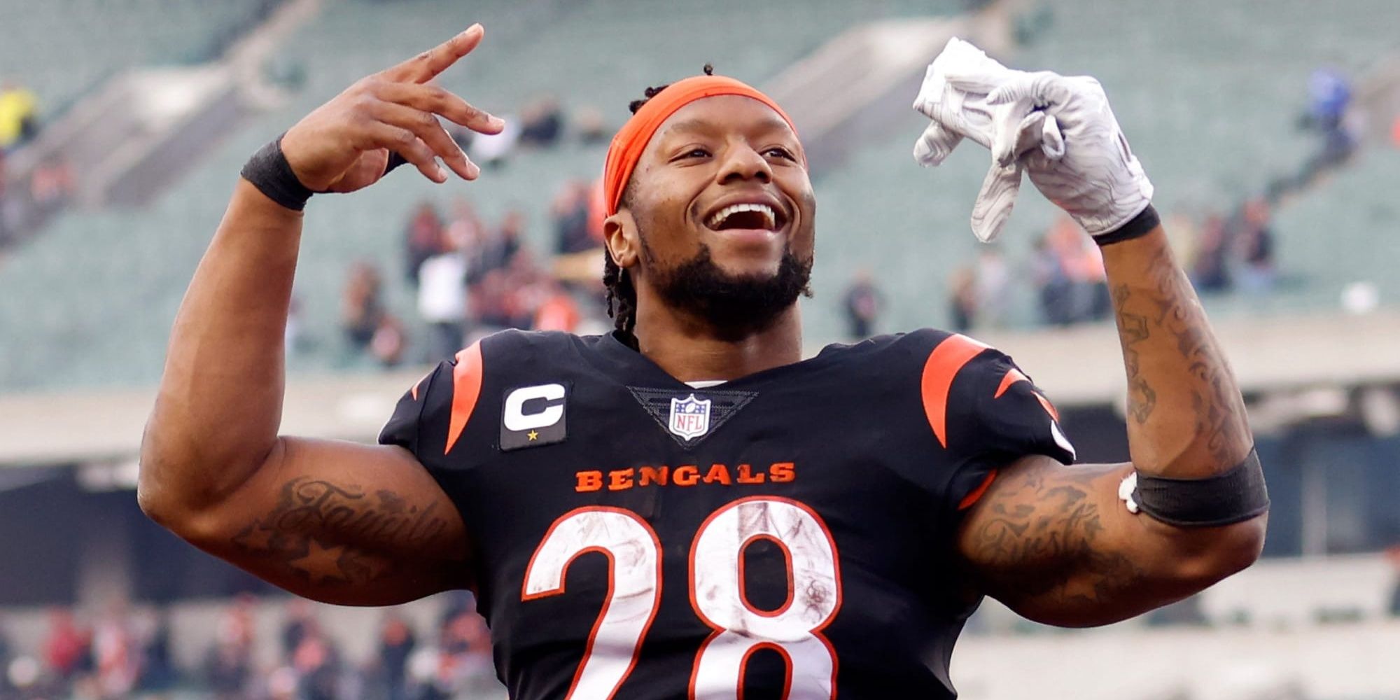 Joe Mixon celebrating in black and orange striped Bengals jersey