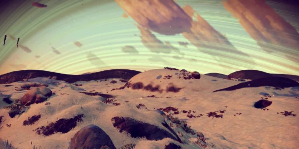 a wide shot of a murky, brown planet from No Man's Sky filled with low hills and brown foliage 