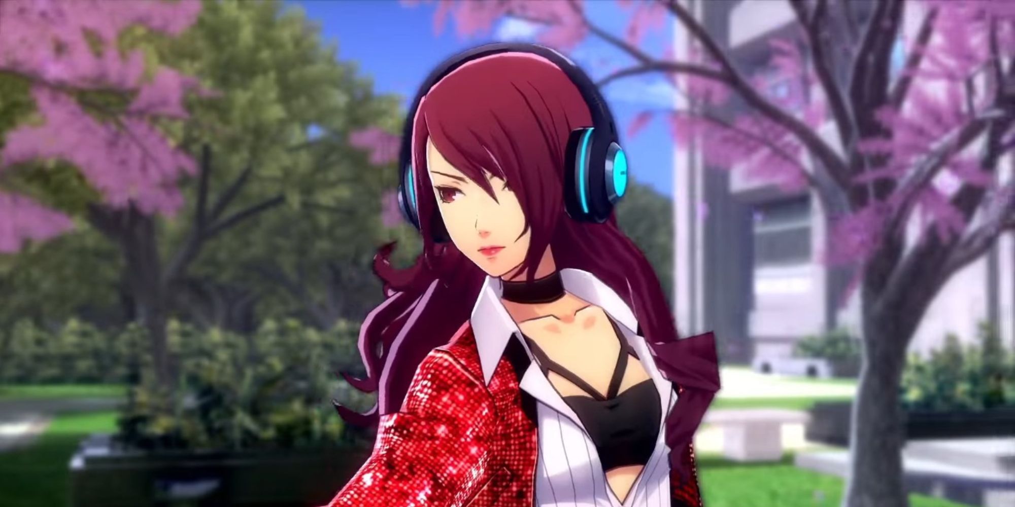 a shot of Mitsuru Kirijo from Persona 3 Dancing In Moonlight wearing headphones against a backdrop of cherry blossom trees and a school building