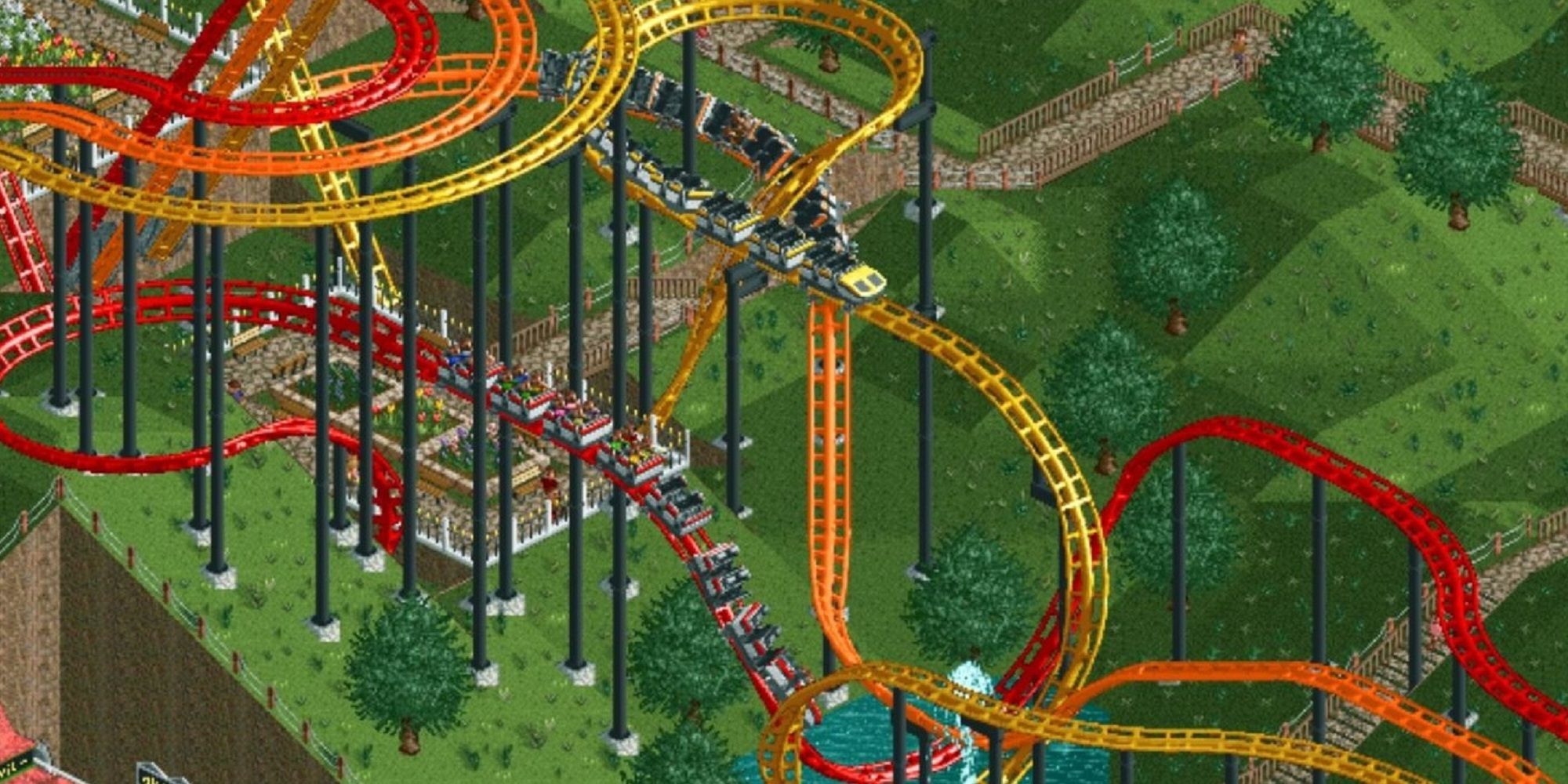 Screencap from Rollercoaster Tycoon game showing red, orange, and yellow coaster