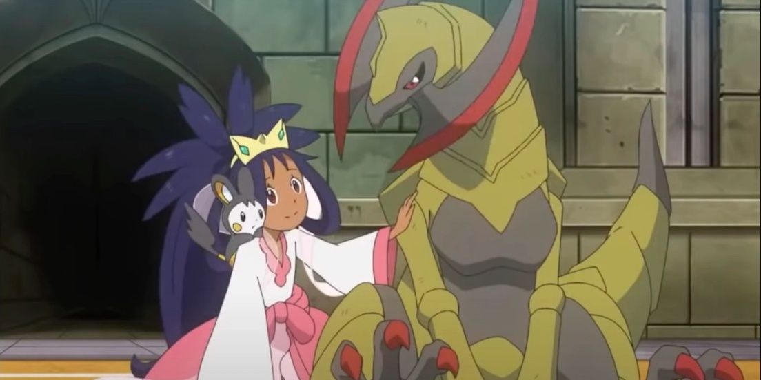 Iris in her chamipon garb petting Haxorus with an Emolga on her shoulder