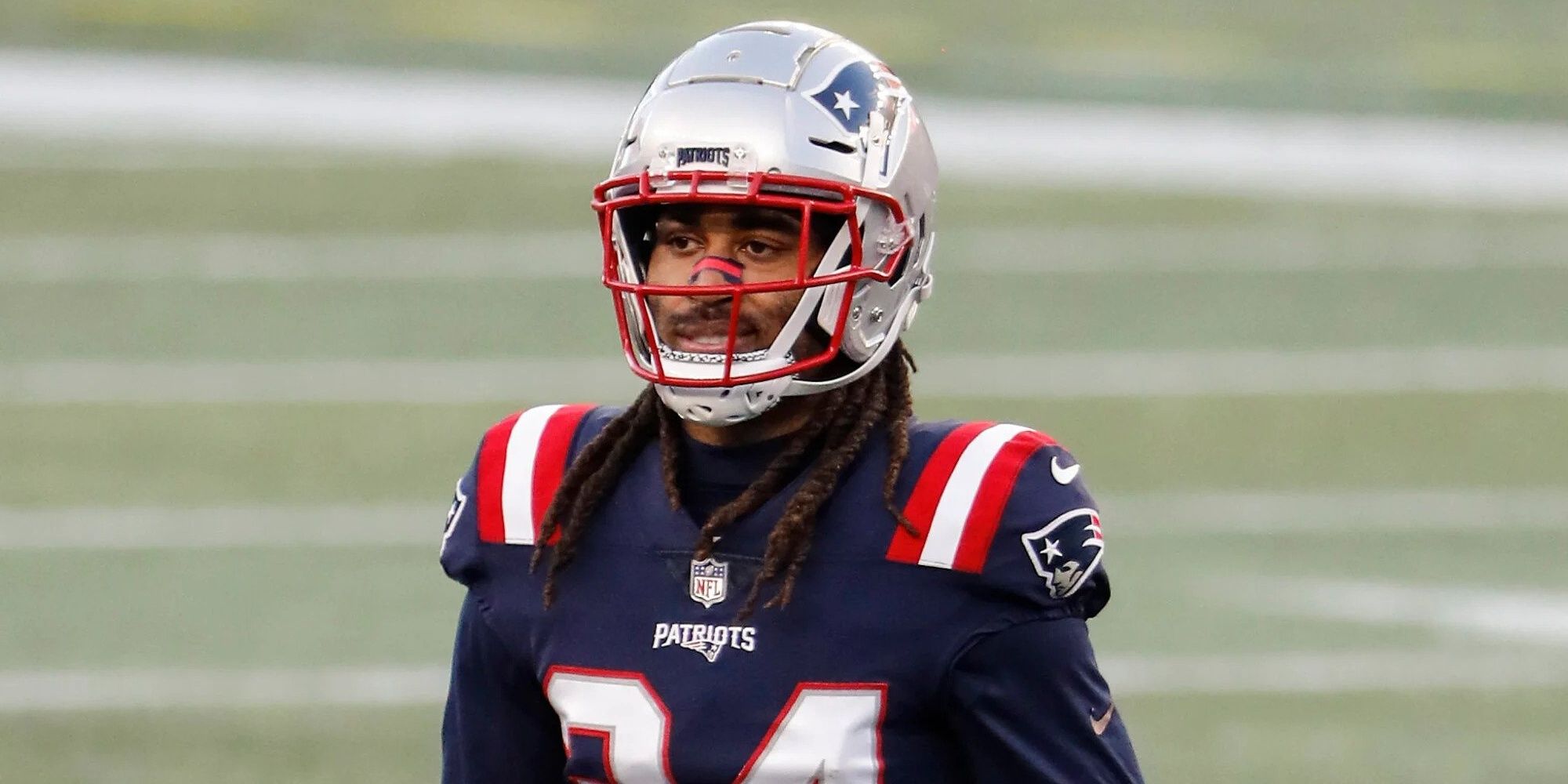 Stephon Gilmore in a blue Patriots uniform