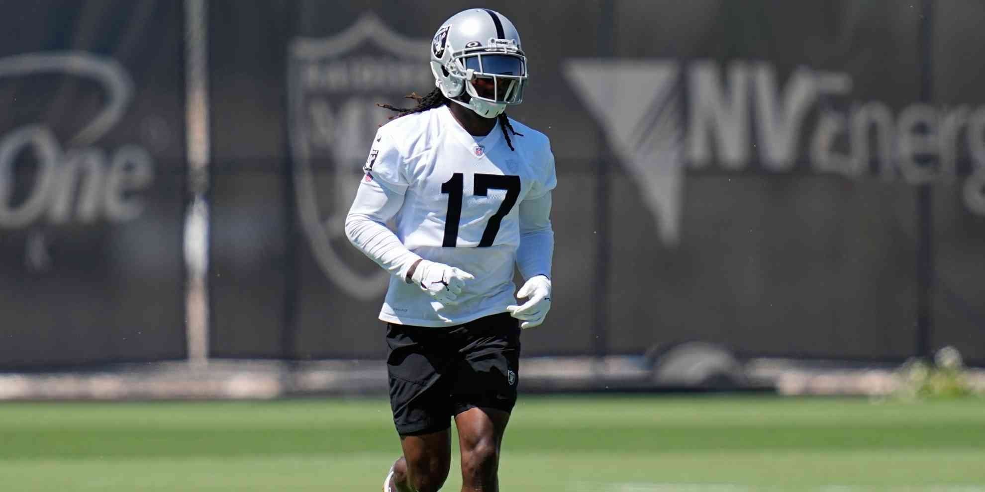 Davante Adams jogging in a white Raiders jersey