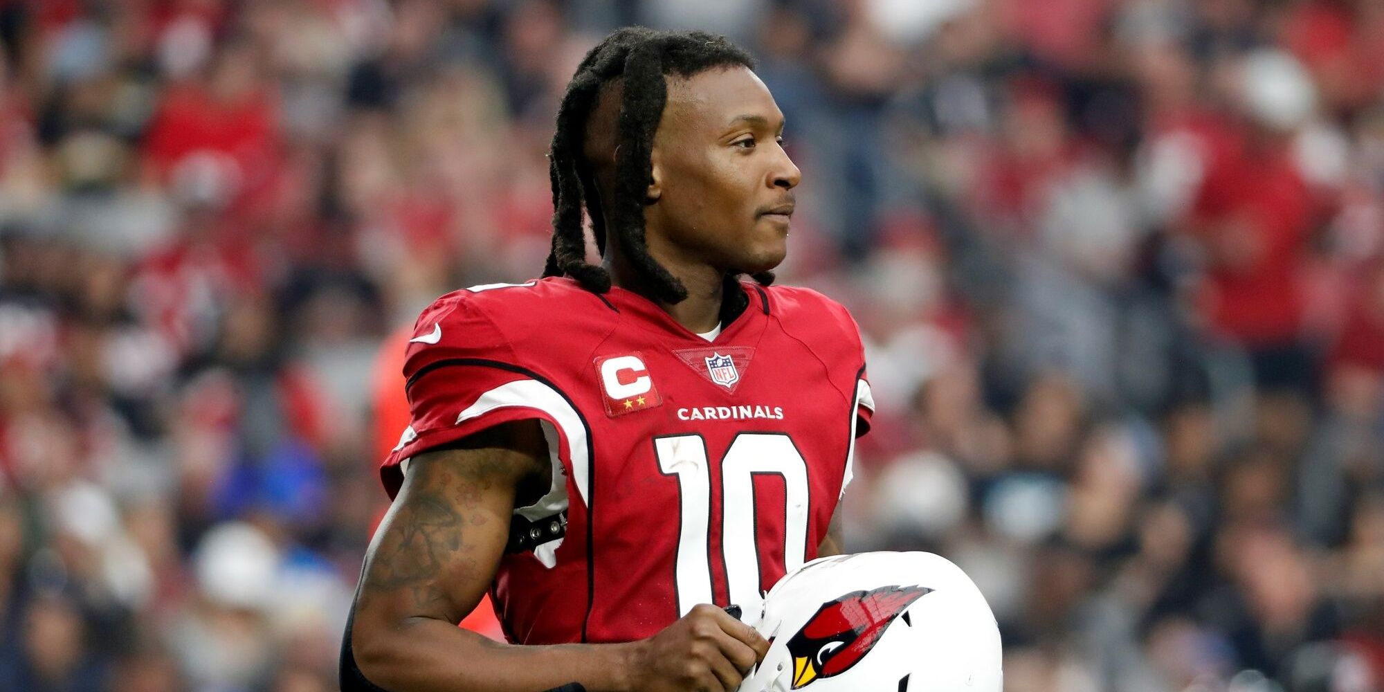 DeAndre Hopkins standing with his helmet off in a red Cardinals jersey