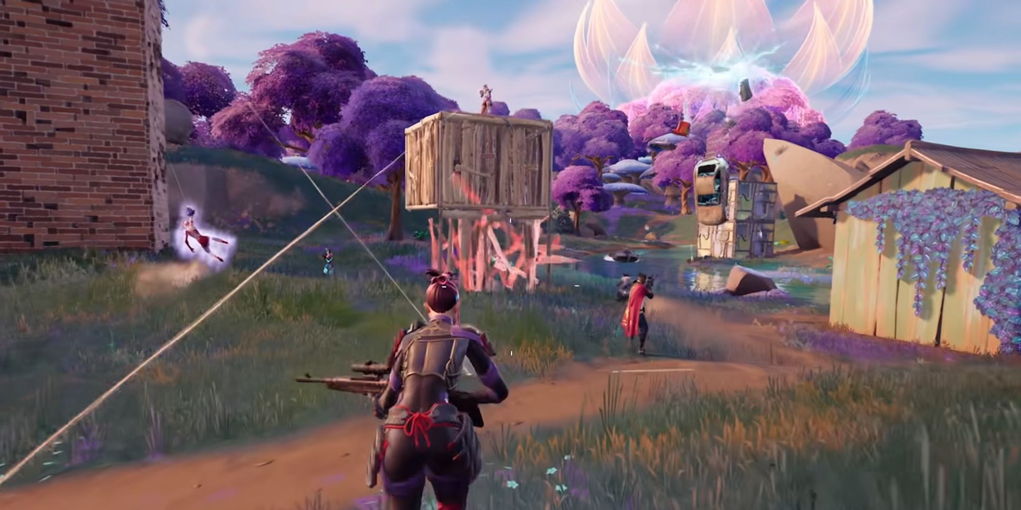 A group of players in Fortnite start running towards a built fort with an enemy player on top shooting.