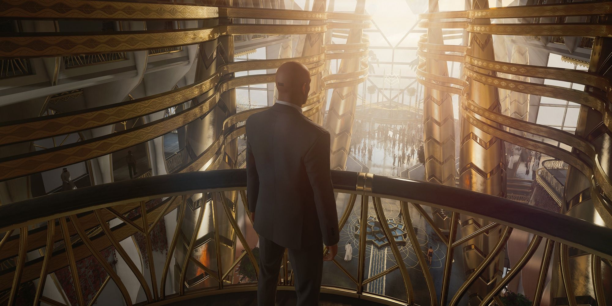 Agent 47 looking out over a balcony inside a massive, gold building in Hitman 3