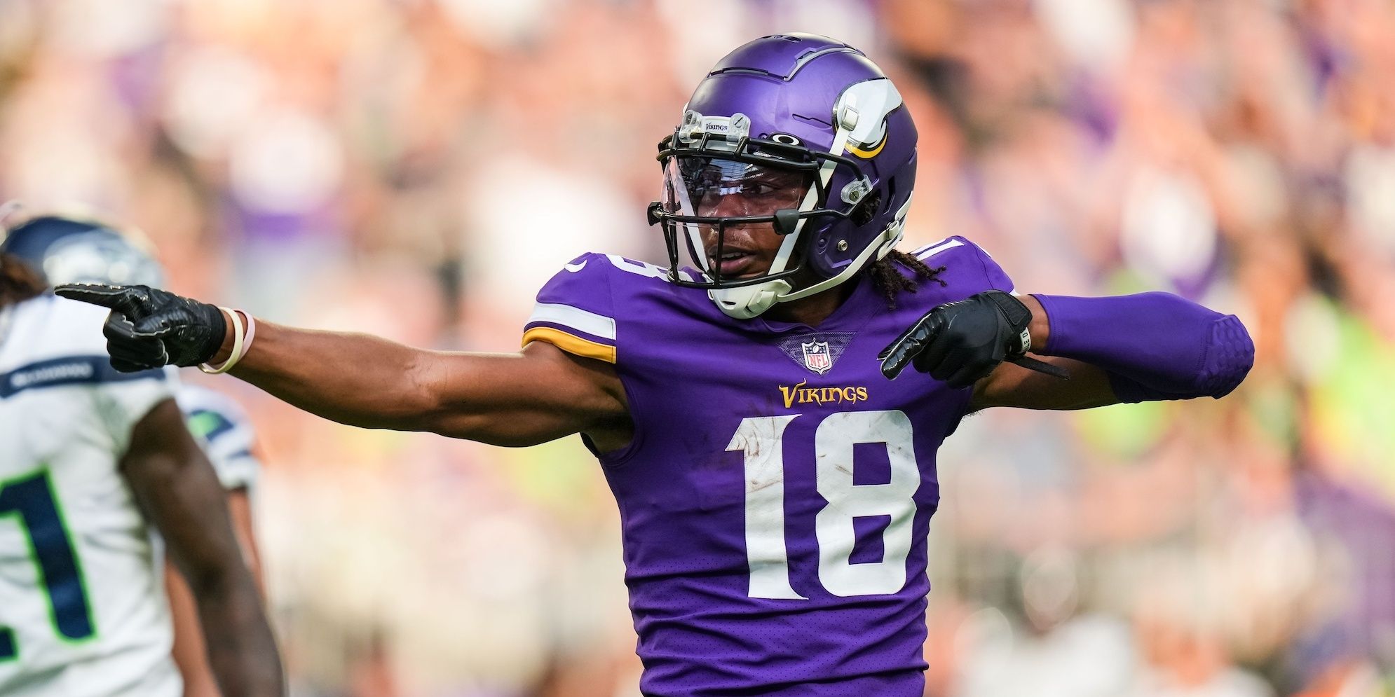 Justin Jefferson pointing to celebrate a first down in a purple Vikings jersey