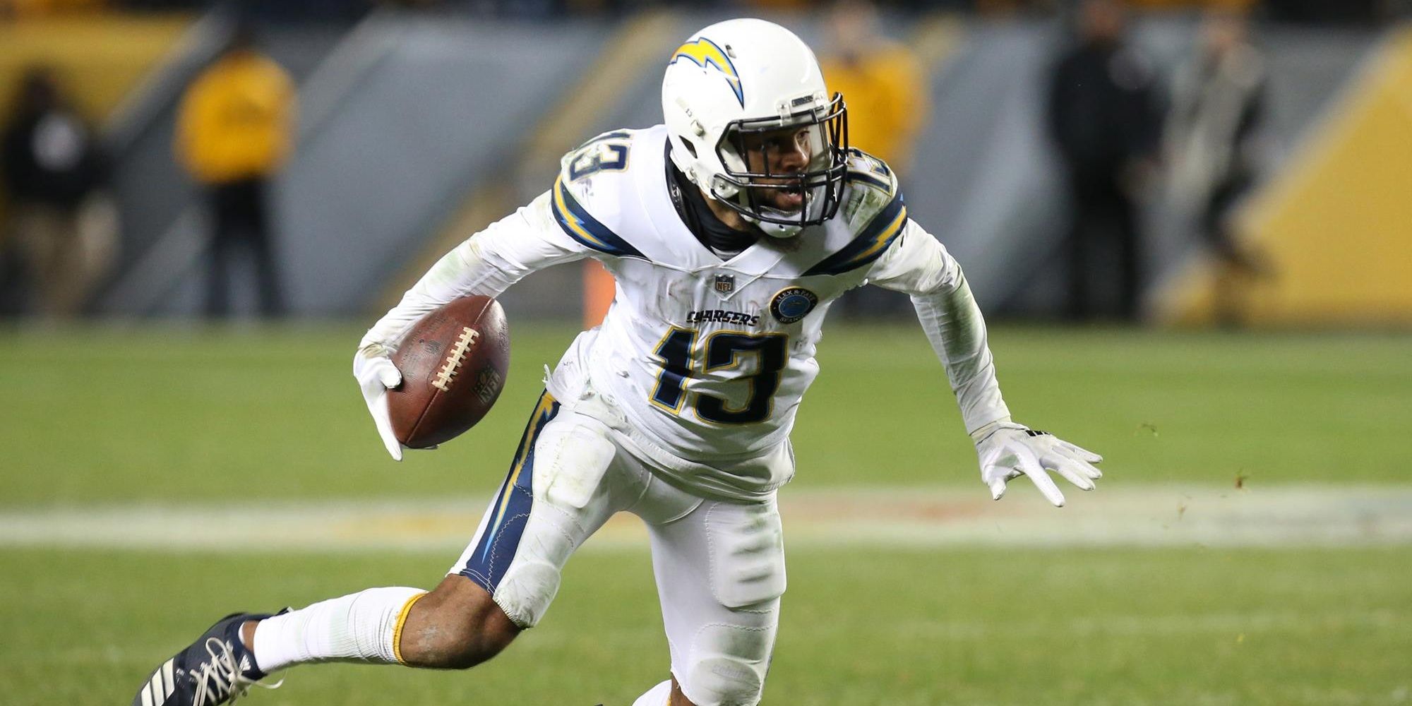 Keenan Allen running with the ball in a white Chargers uniform