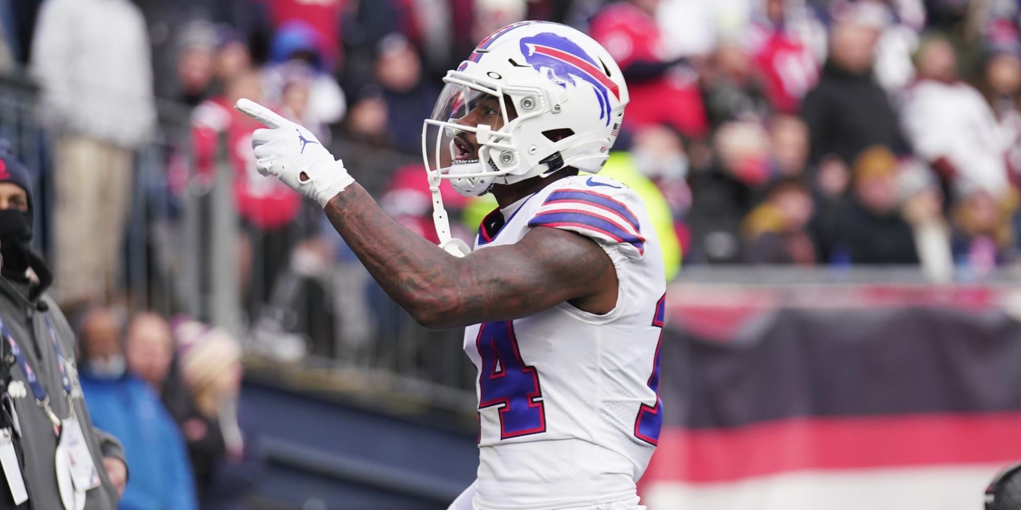 Stefon Diggs celebrating a catch in a white Bills jersey