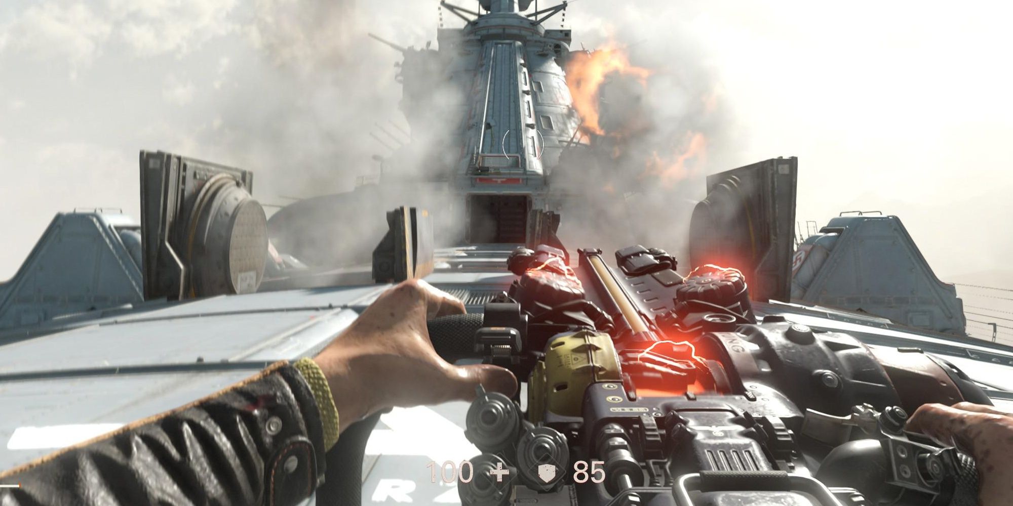 B.J. Blazkowicz using a handheld turret to take down enemies above a ship in Wolfenstein 2: The New Colossus
