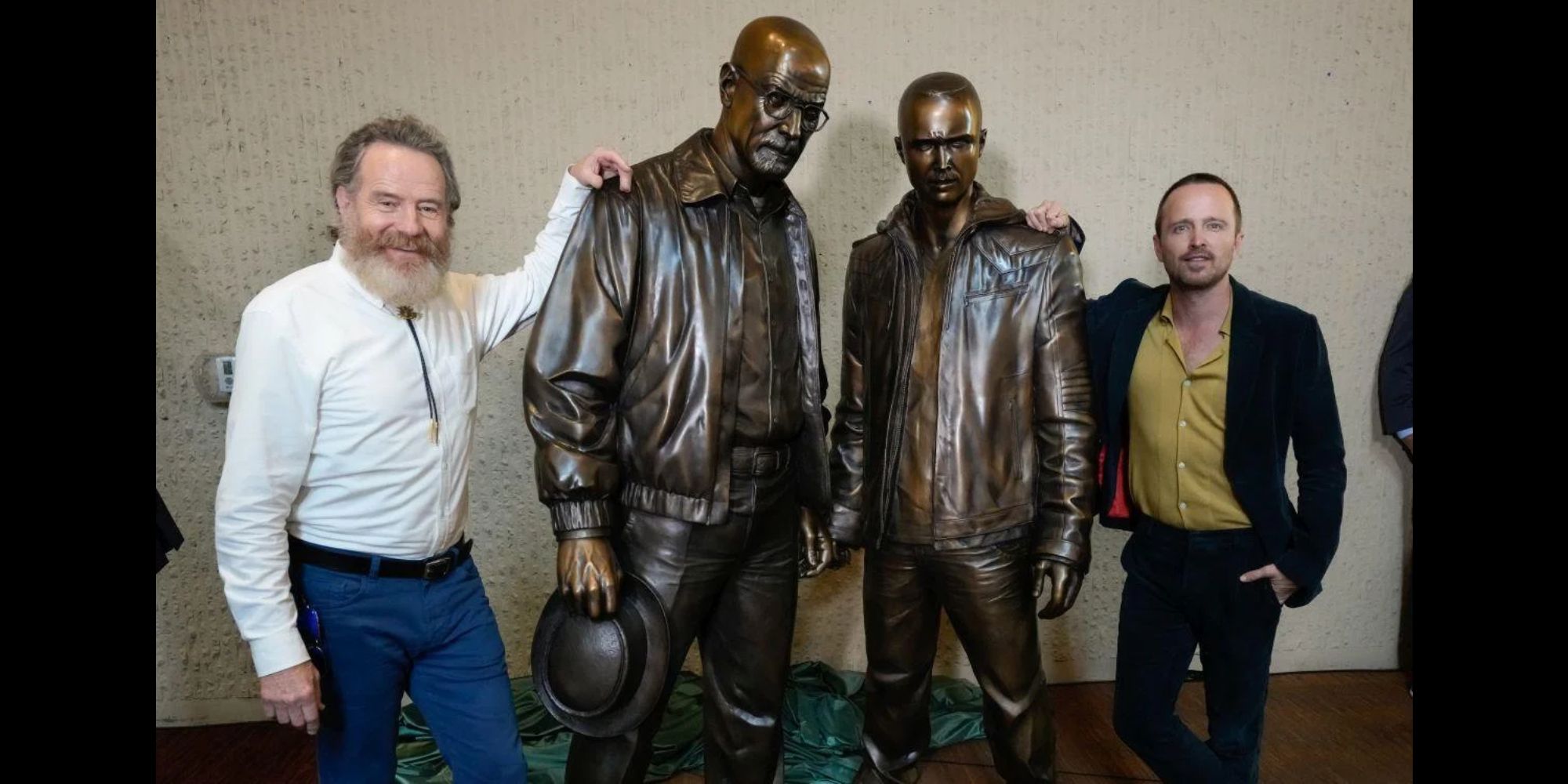 Statues of Walter White and Jesse Pinkman next to Bryan Cranston and Aaron Paul