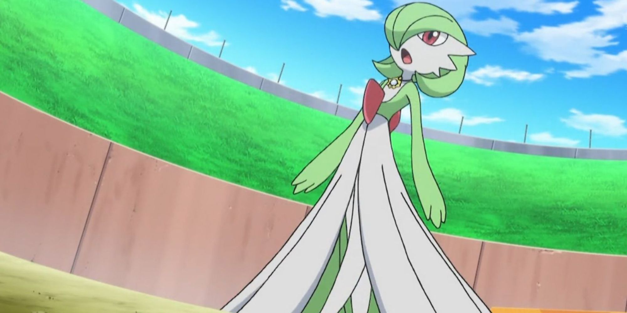 Gardevoir stands in a stadium surrounded by grass