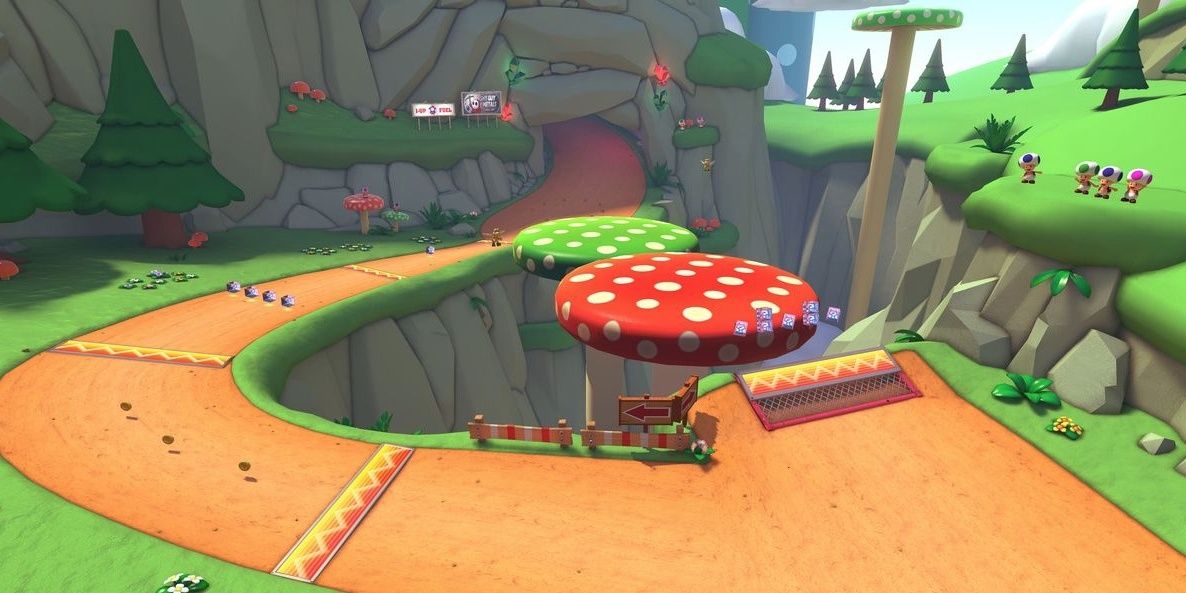 A split track with a curve to one side and two giant mushrooms filling a gap on the other 