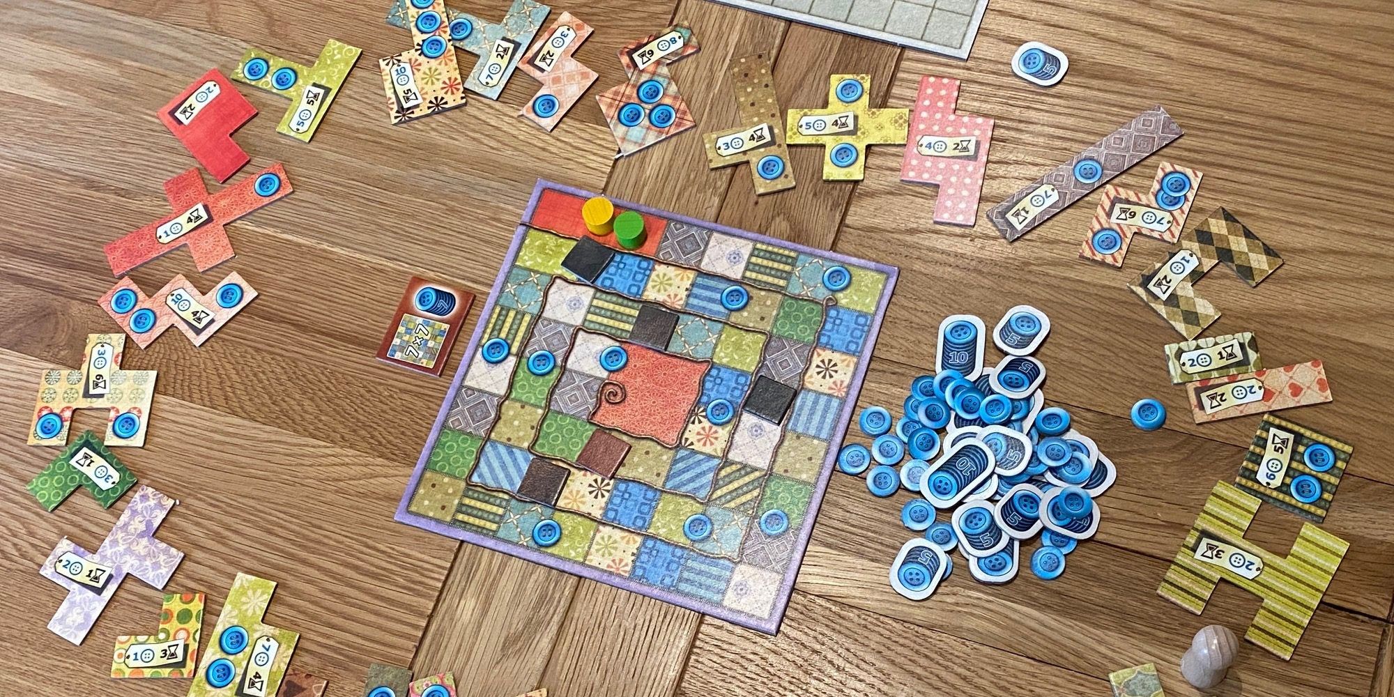 Patchwork Board Game Board and pieces scattered on wooden table