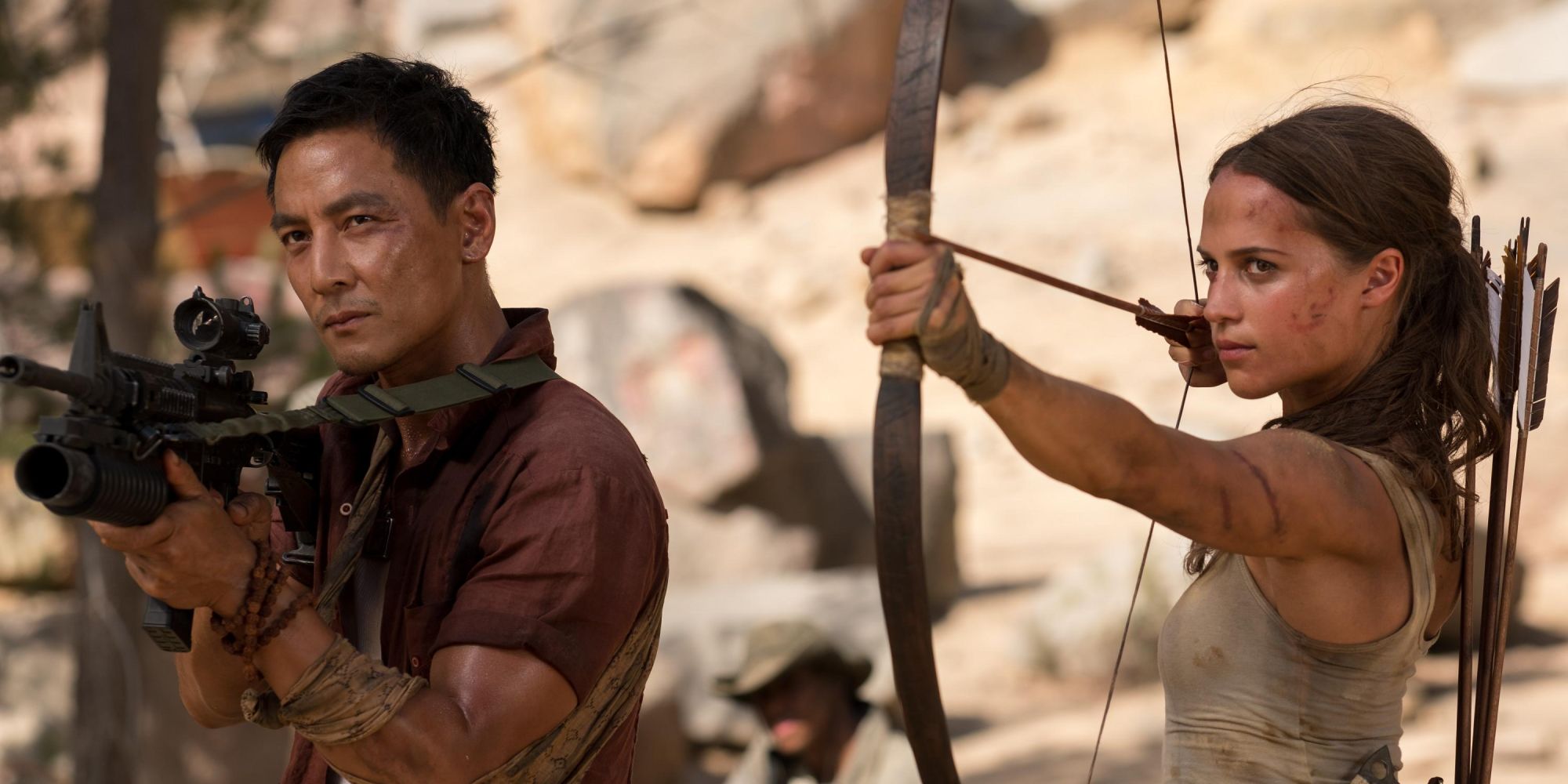Alicia Vikander and Daniel Wu holding weapons in Tomb Raider 2018