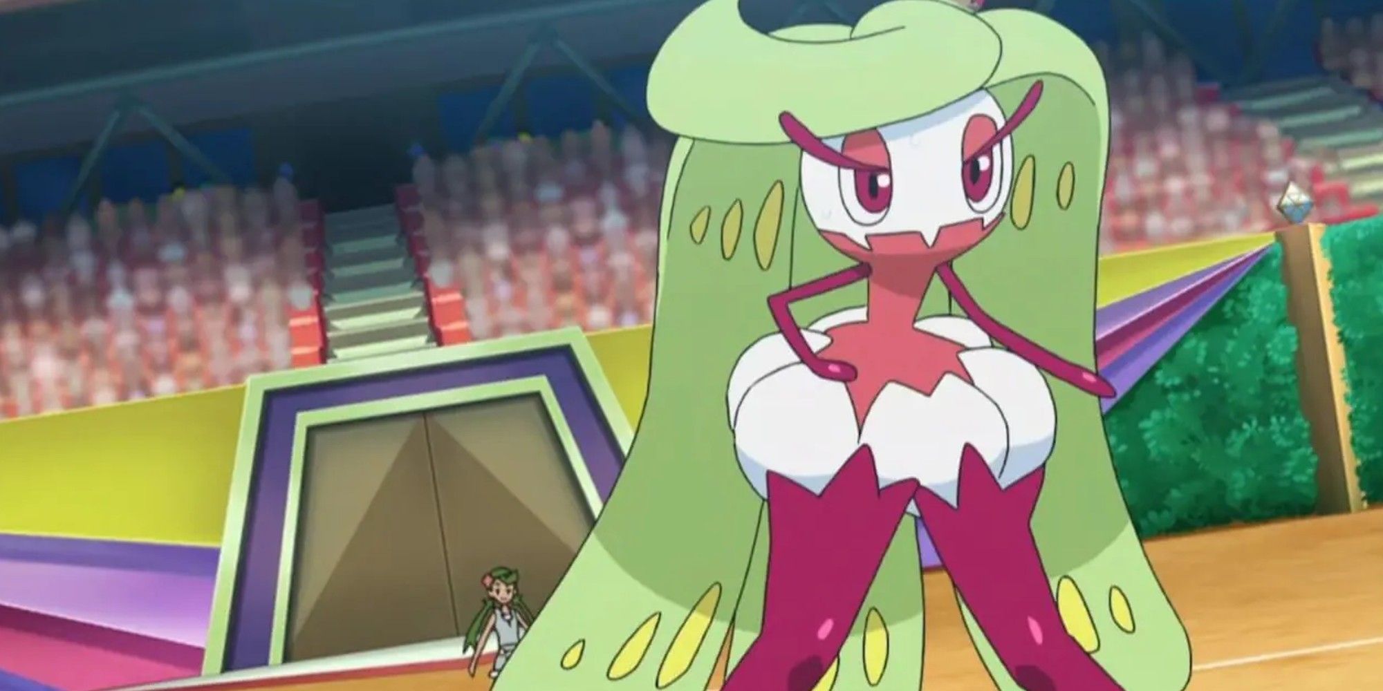 Tsareena from the anime looking ready to fight, with Mallow in the backgroun, inside a stadium