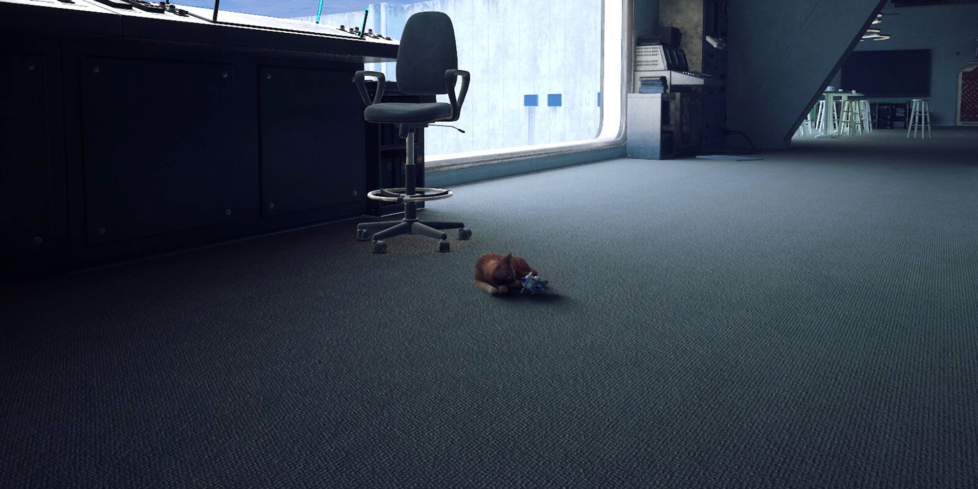 the stray curls up with b12's body on the floor of the control room