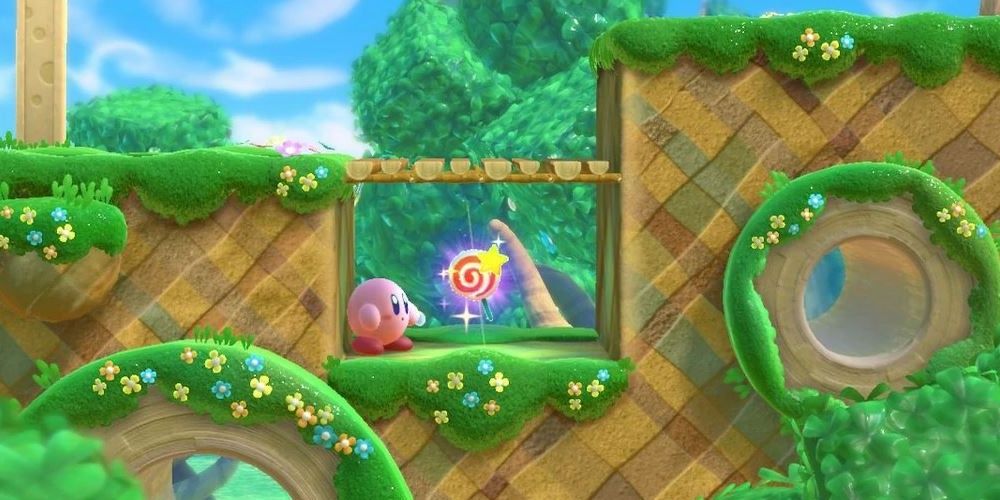 Kirby looking at an Invincibility Candy in Kirby Star Allies