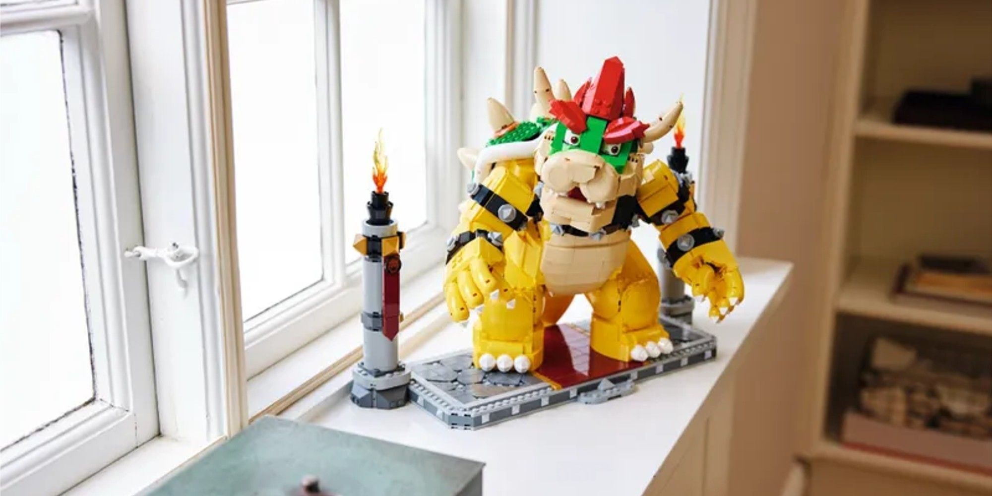 Lego Bowser on a shelf by the window