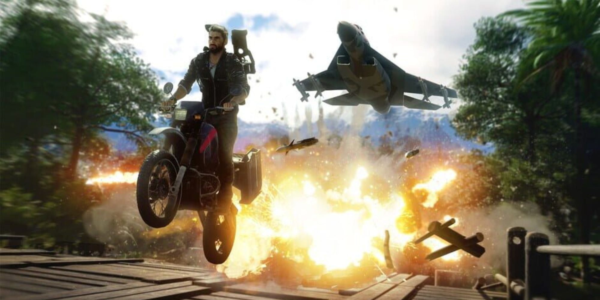 Rico drives a motorcycle away from an explosion as he is pursued by a plane