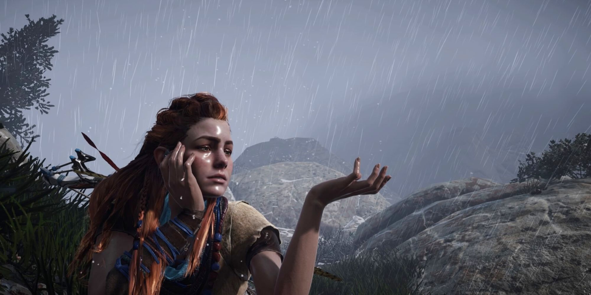 Aloy sits in the rain outside and catches droplets in her hand