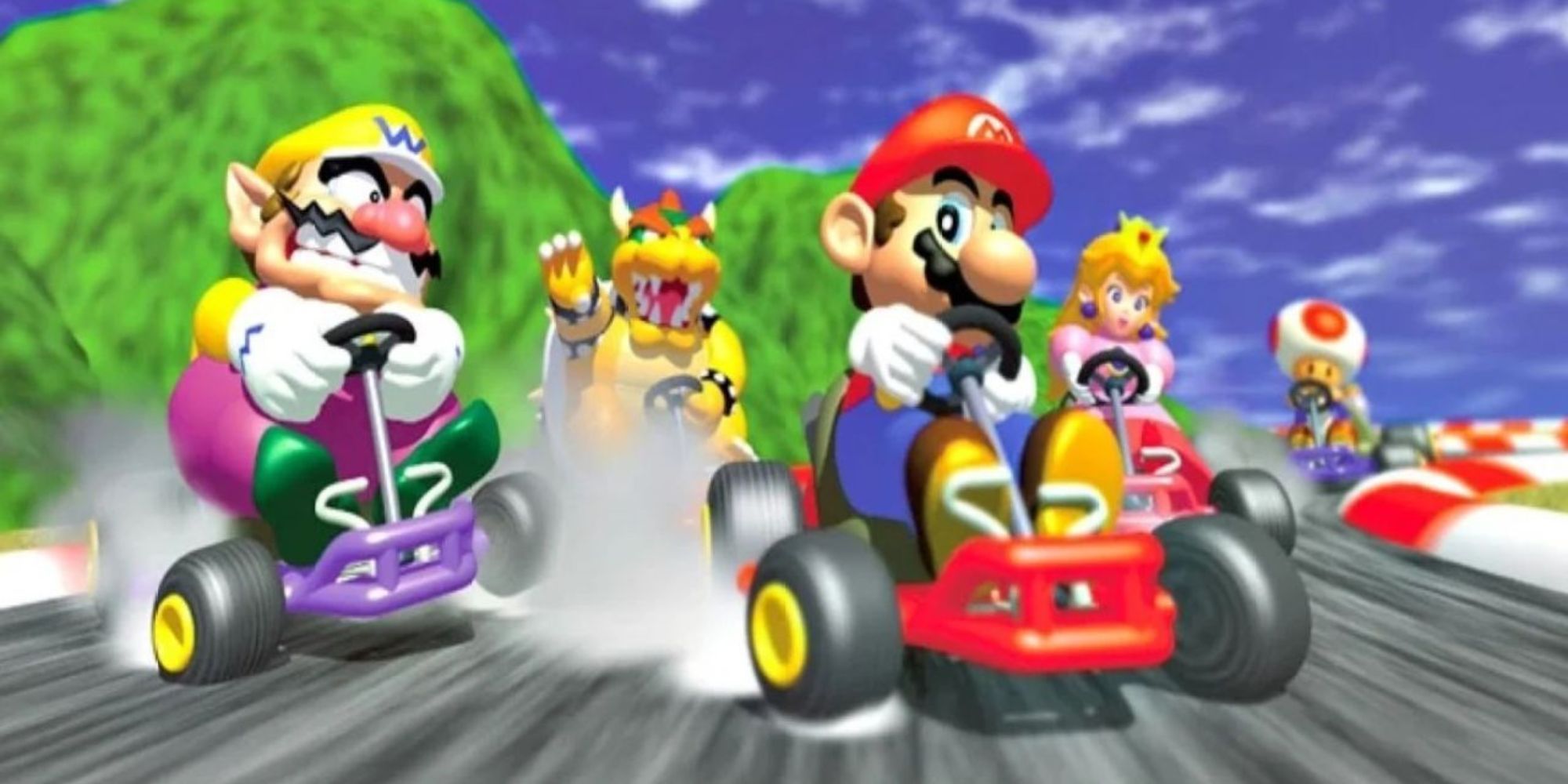 Mario and Wario drift around a corner followed by Bowser, Peach, and Toad