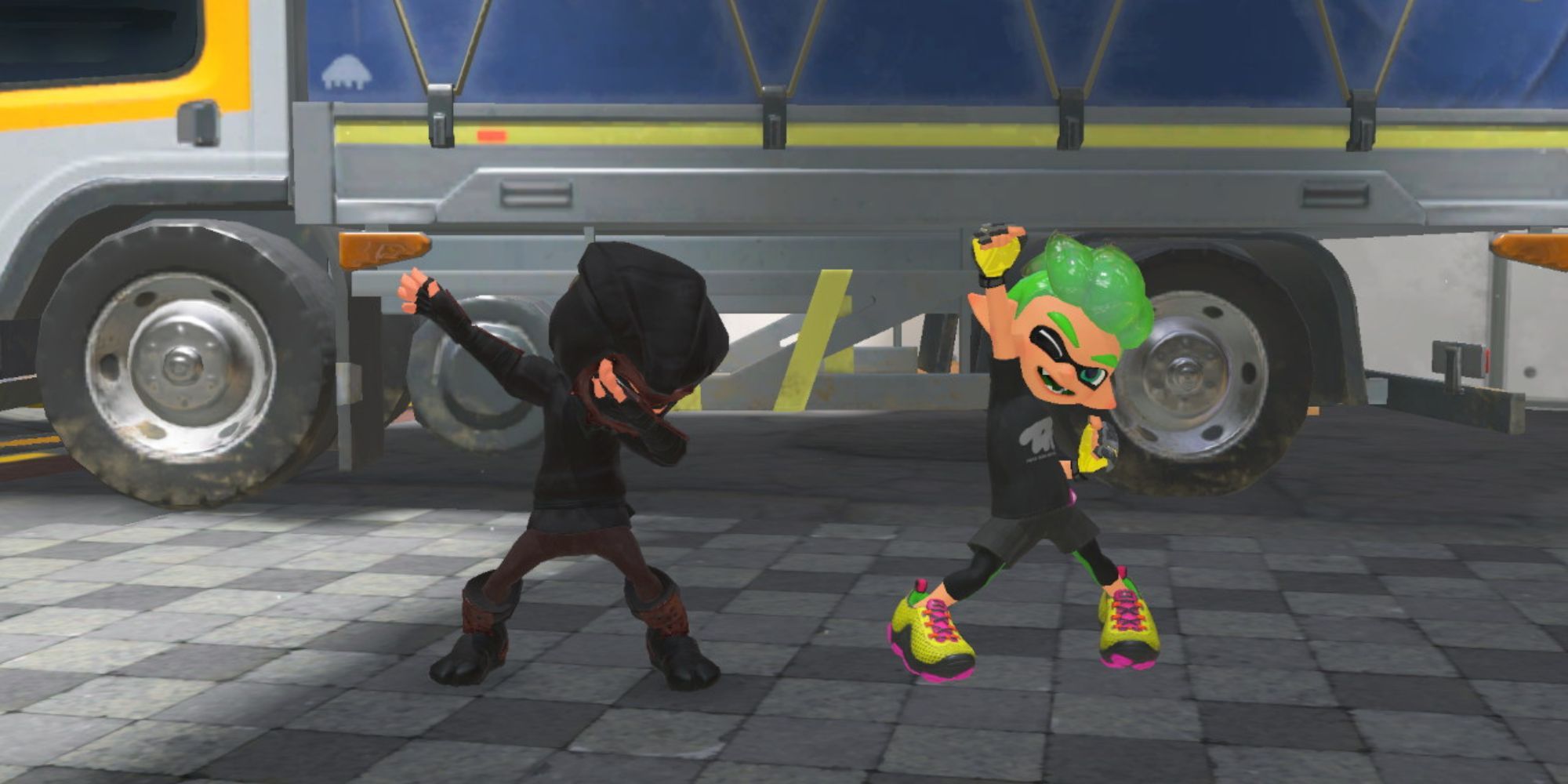 An Inkling wearing the Squinja Outfit dabs beside an Inkling boy by a truck