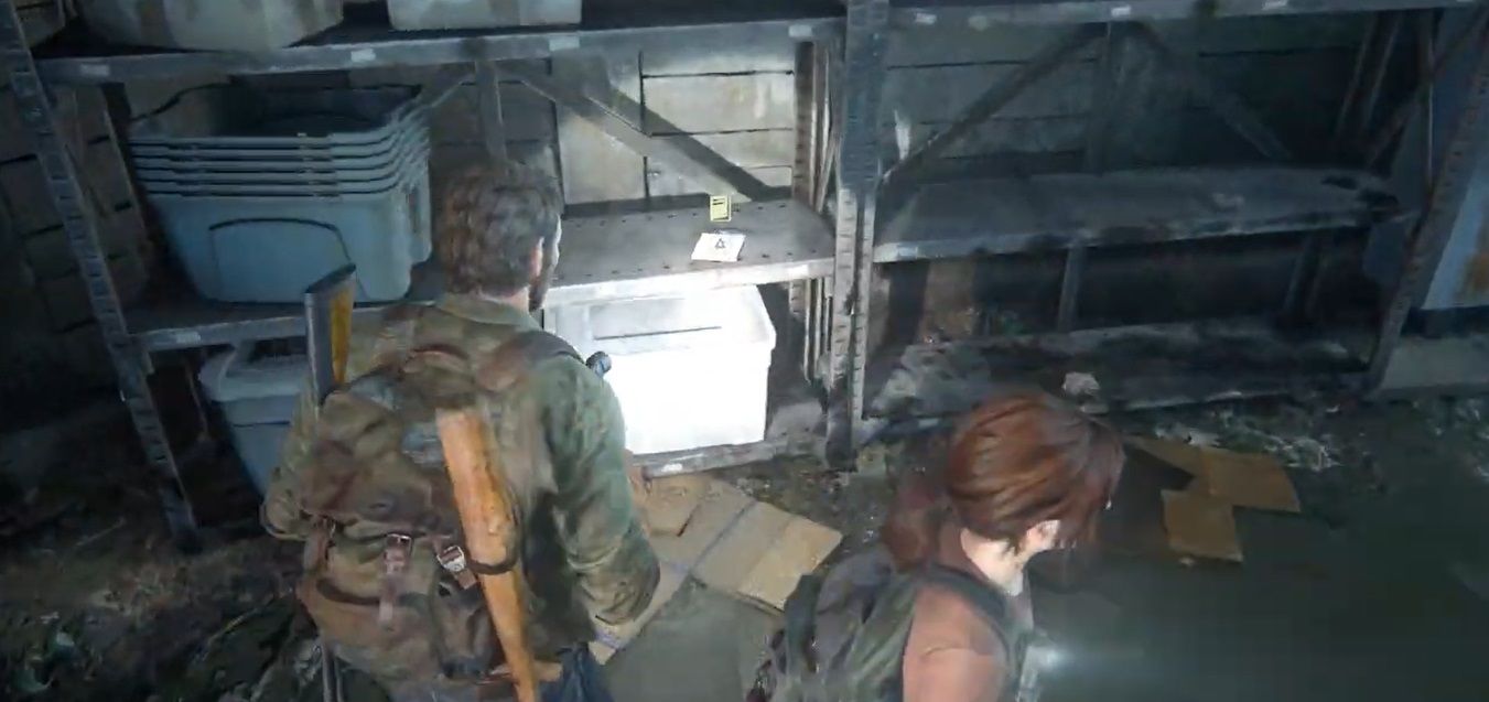 Joel Miller and Ellie Williams stands next to a shelf inside a sewer in The Last of US Part I
