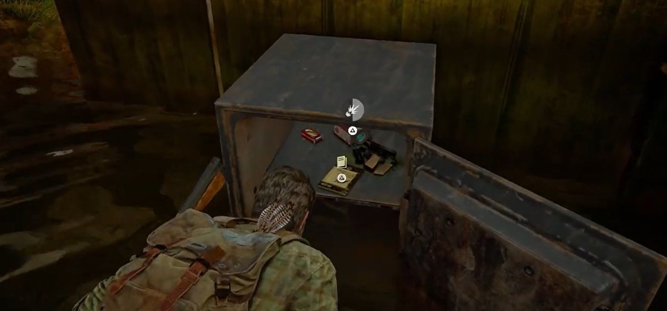 Joel Miller crouches and looks inside a safe in The Last of US Part I