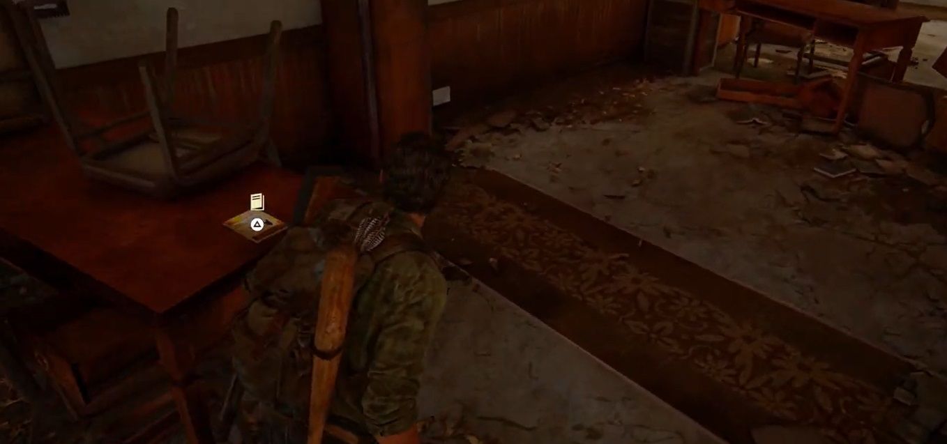 Joel Miller looks at a booklet on a table in The Last of US Part I