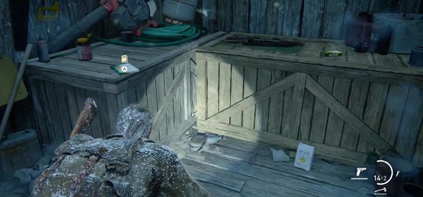 Joel Miller crouches inside a wooden shed in The Last of US Part I