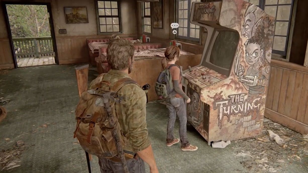 Joel watches as Ellie plays with the arcade machine in The Last of Us Part 1
