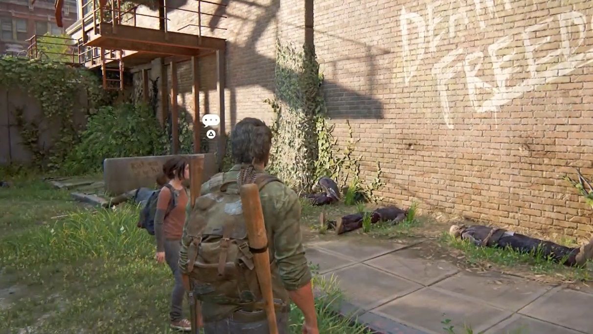 Joel and Ellie look at dead people killed and laid near a brick wall in The Last Of Us