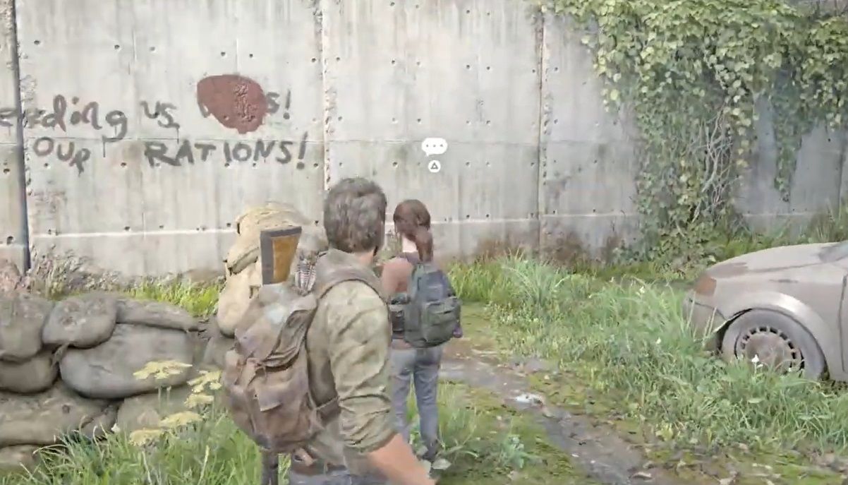 Joel and Ellie look at a graffiti on the wall of FEDRA checkpoint in The Last of Us Part 1