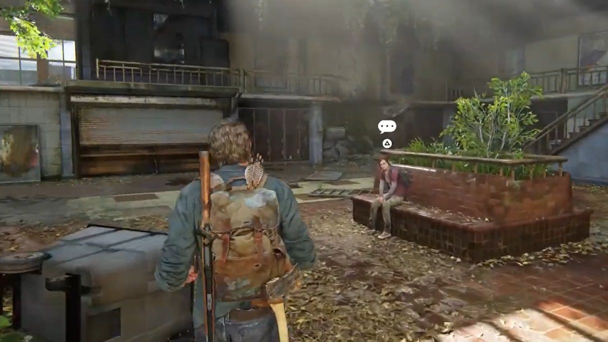 Joel walks to Ellie as she sits on a brick-made bench at bus station in The Last of Us Part 1