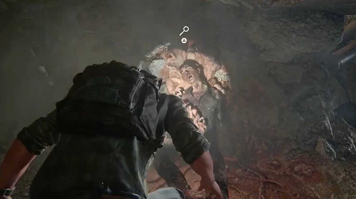 Joel crouchs into a dead man into spores in The Last of Us Part 1