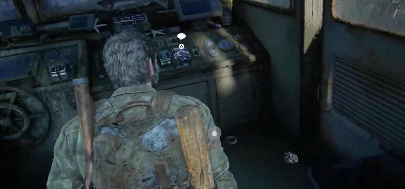 Joel looks at the helm of a boat in The Last of Us Part 1