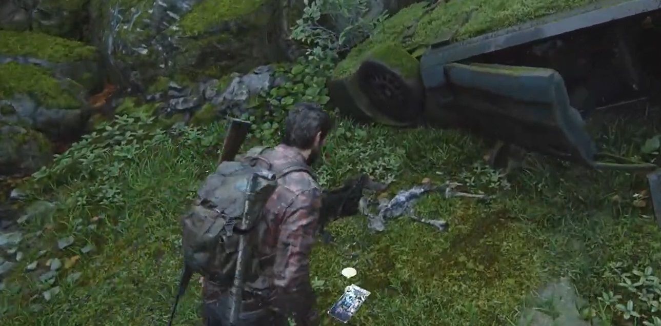 Joel is near a crashed car beside some rocks in The Last of Us Part 1