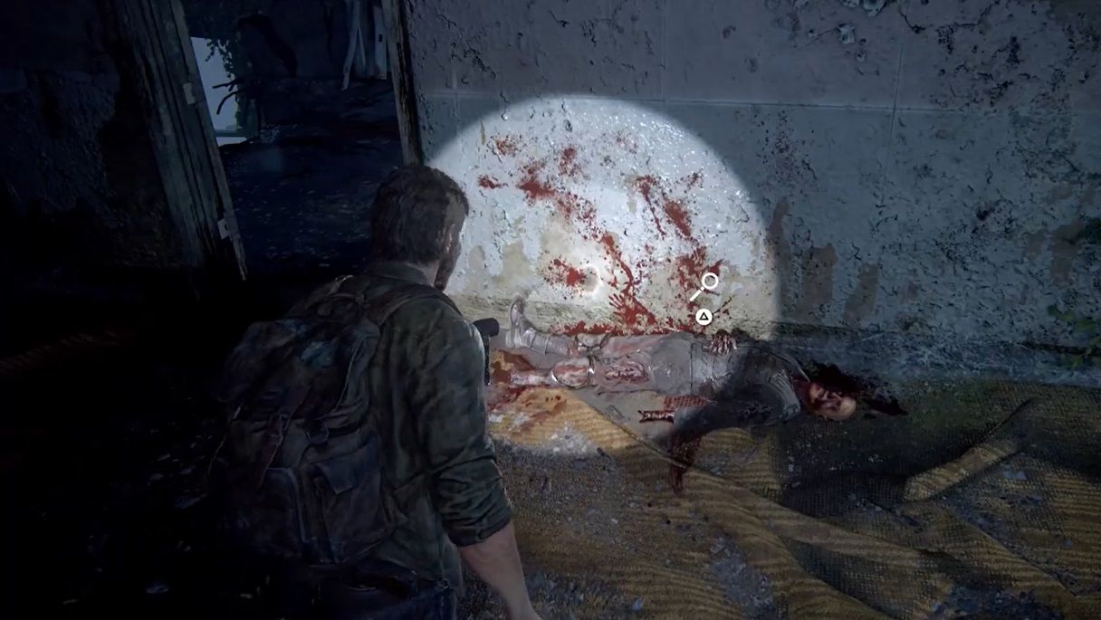 Joel look at a dead soldier on the ground by the wall in The Last of Us Part 1