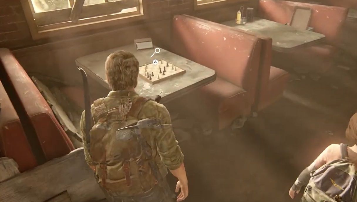 Joel looks at a chess board on a restaurant table in The Last of Us Part 1